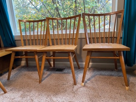 Three of the wooden dining chairs.