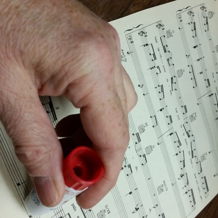 Gluing sheet music for rolls.