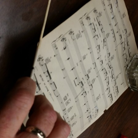 Rolling up sheet music.