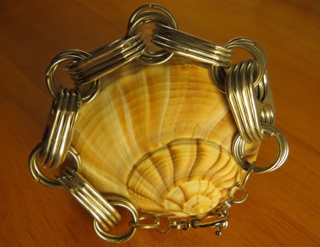The completed bracelet on a shell.
