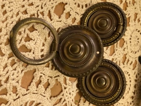 The metal drawer hardware.