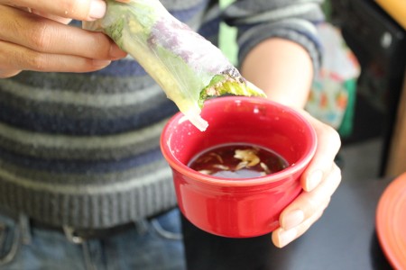 Enjoying a fresh beef spring roll.