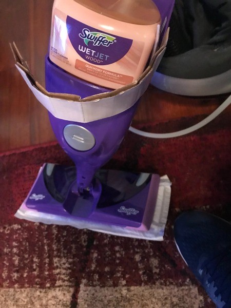 A Swiffer WetJet and the cardboard inside.