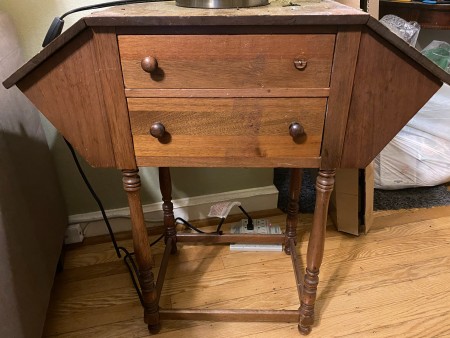 A hexagonal table with two drawers.