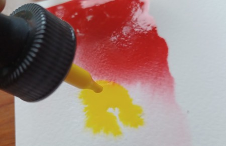 Adding paint to the paper.