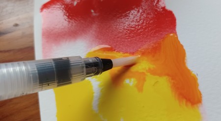 Adding more water to the painting.