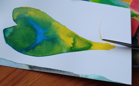 Cutting out the heart shaped painting.