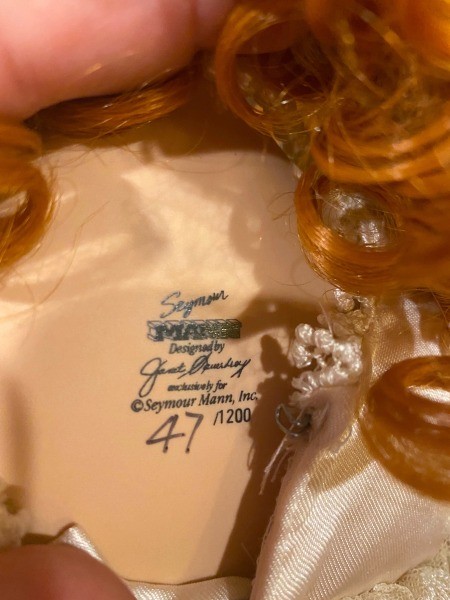 The marking on the back of the doll's neck.