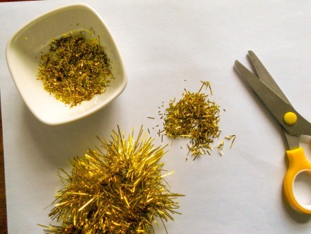 Making pieces of glitter from a garland.