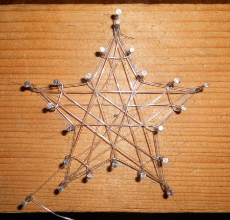 Adding fishing line to the star frame.