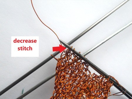 Knitting the copper wire into a heart.