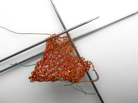 Knitting the copper wire into a heart.