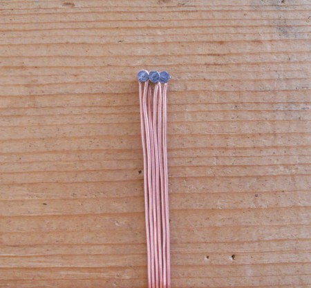Attaching the wires to a nail.