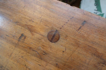 a screw on the seat of the bench.