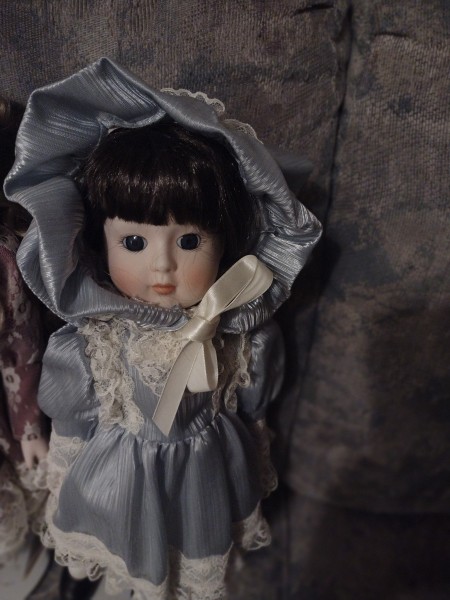 A dark haired porcelain doll.