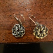 A pair of clean silver earrings.