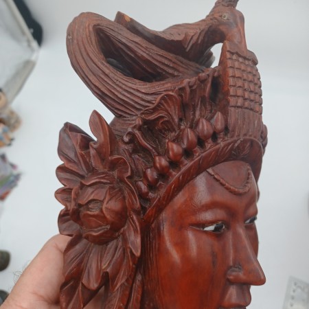 The carved side of a wooden mask.
