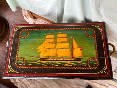 A sailing ship painted on a trunk.