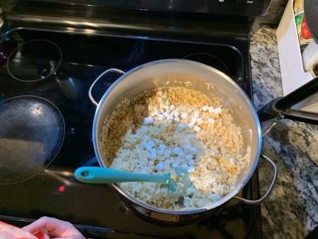 Stirring the rice krispie treats.