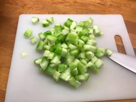 Cutting up cucumbers.