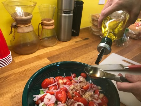 Adding oil to the salad.