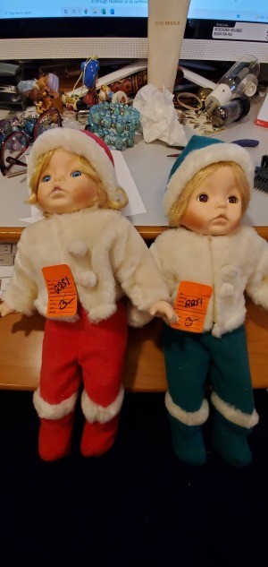 Two small blonde dolls in winter clothing.