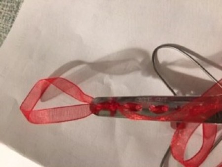 Adding ribbon to an old perm rod.