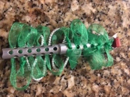 Adding green ribbon to a perm rod.