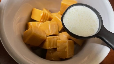 Adding cream to caramel squares.