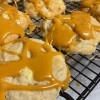 Allowing the caramel to cool on the cookies.