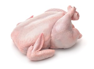 An uncooked turkey on a white background.