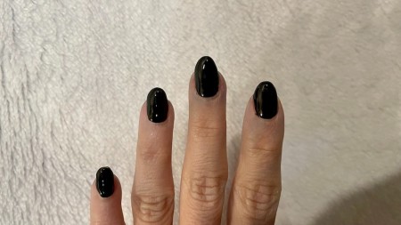 A hand with nails painted black.