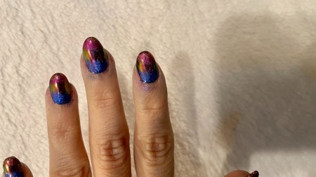 Adding chrome powder to the nails.