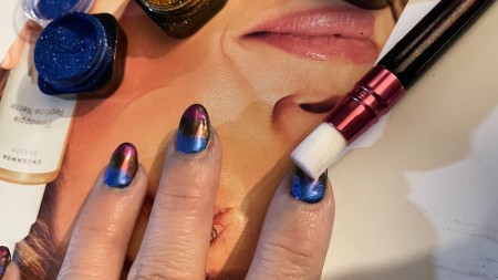 Removing excess powder from the nails.