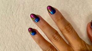 A hand with an oil slick manicure.