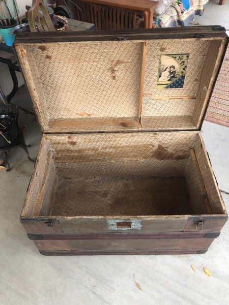 The open lid of an old trunk.
