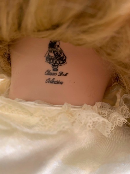 The back of a doll's neck with the manufacturer's marking.