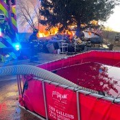 A house on fire while the firefighters are there.