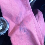 A purple stain on a pair of pink jeans.