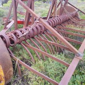 A rusted piece of farm equipment.