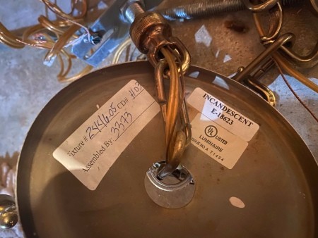 The markings on the back of a chandelier.