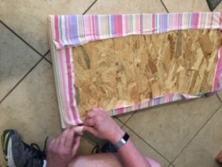 Attaching fabric to the bench seat.