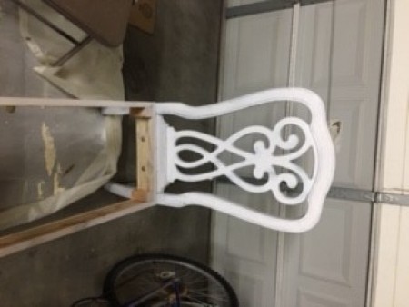 Painting the wooden chairs white.