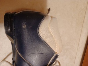 A cross country boot with wear.