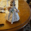 A small porcelain figurine of a young girl.