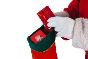 Santa putting a present into a stocking.