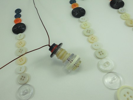 Twisting the wire to hold the snowman together.