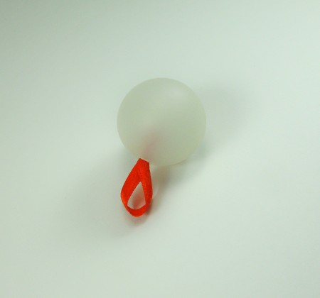 Adding a ribbon to the ball.