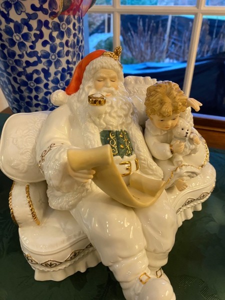 A figurine of Santa and a child.