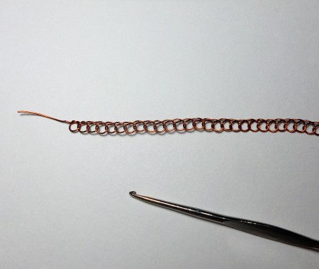 Making a crochet chain out of the copper wire.